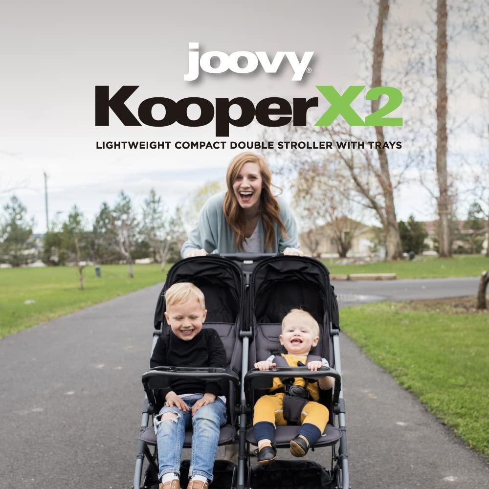 imageJoovy Kooper Lightweight Baby Stroller Featuring Removable SwingOpen Tray Big Wheels Reclining Seat with Footrest ExtraLarge Retractable Canopy and Compact Fold SandBlack