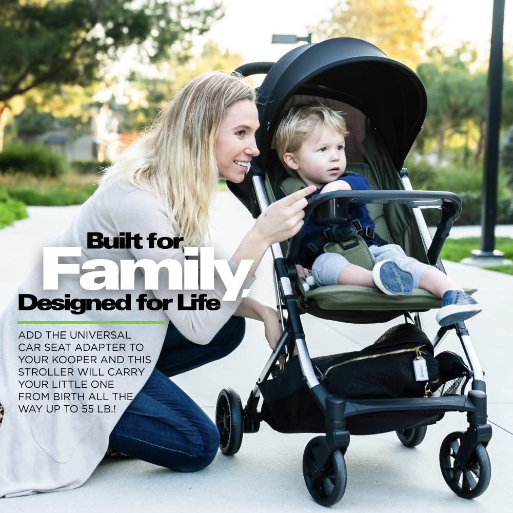 imageJoovy Kooper Lightweight Baby Stroller Featuring Removable SwingOpen Tray Big Wheels Reclining Seat with Footrest ExtraLarge Retractable Canopy and Compact Fold SandBlack