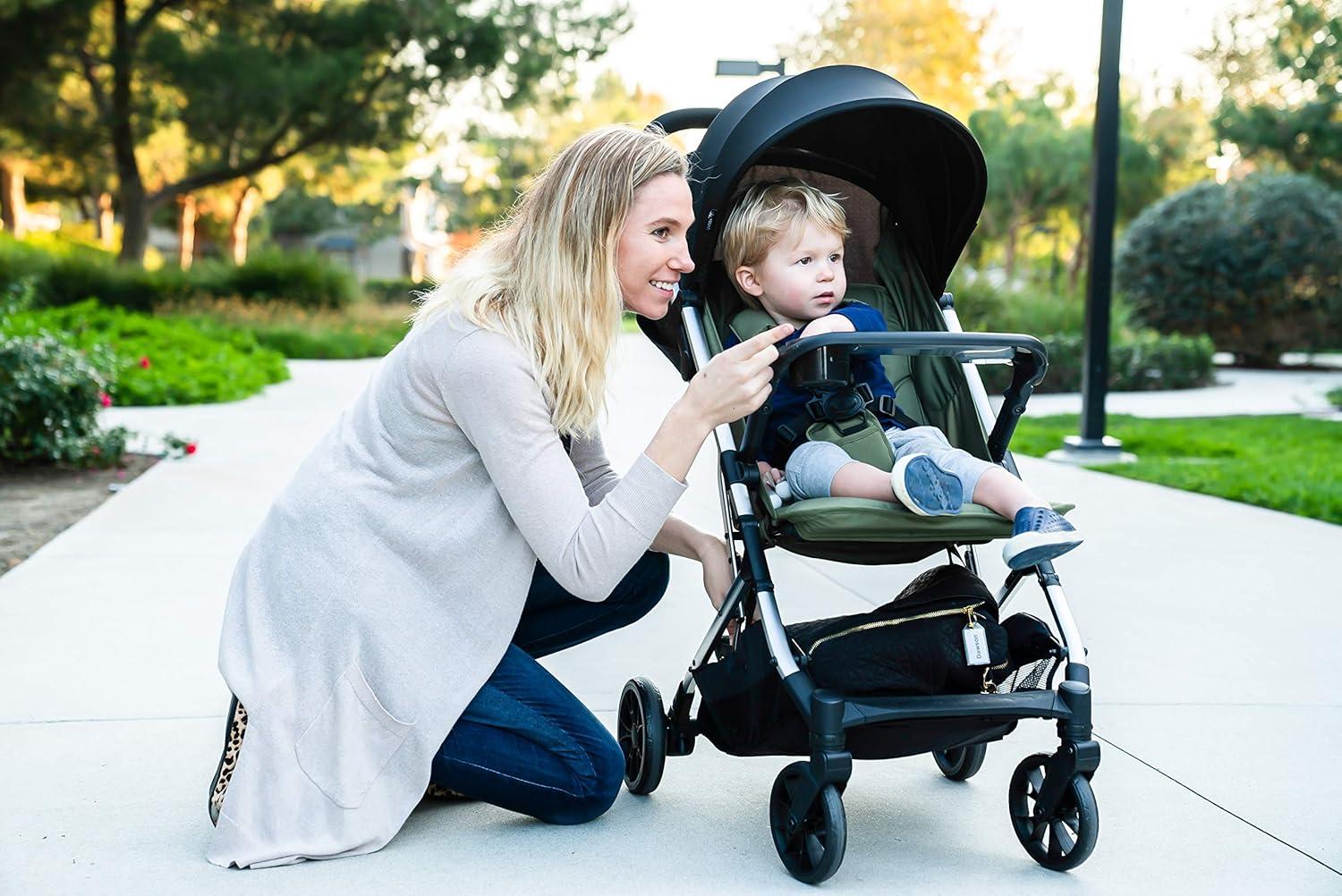 imageJoovy Kooper Lightweight Baby Stroller Featuring Removable SwingOpen Tray Big Wheels Reclining Seat with Footrest ExtraLarge Retractable Canopy and Compact Fold SandOlive