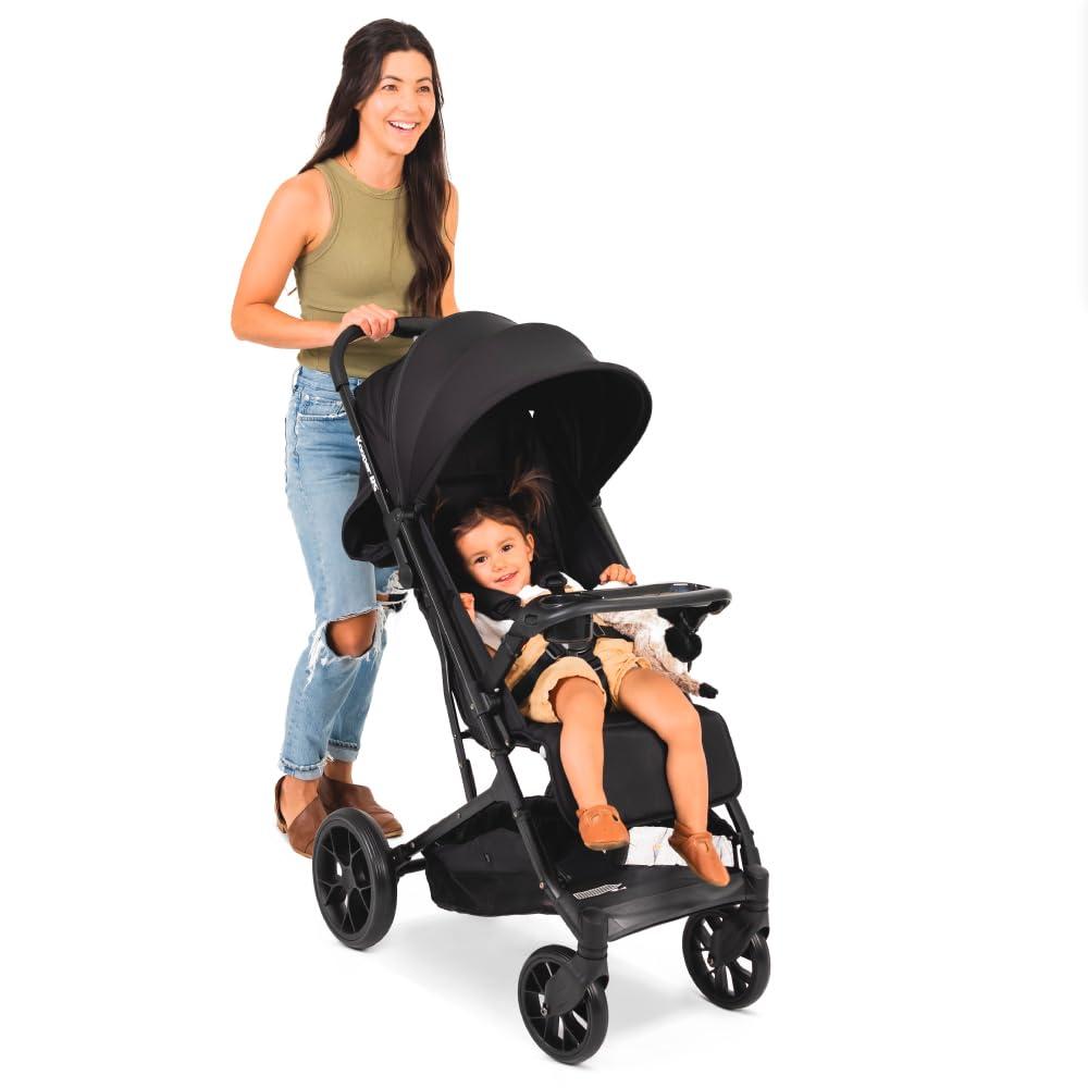 imageJoovy Kooper Lightweight Baby Stroller Featuring Removable SwingOpen Tray Big Wheels Reclining Seat with Footrest ExtraLarge Retractable Canopy and Compact Fold SandBlack