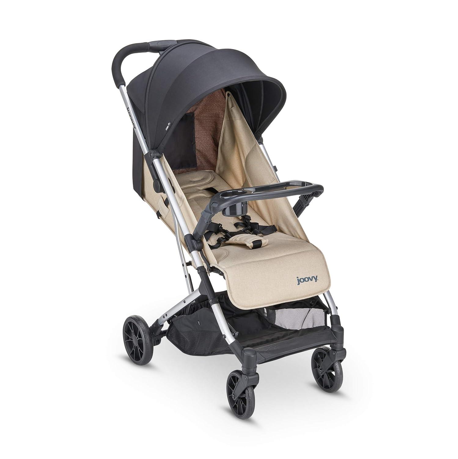 imageJoovy Kooper Lightweight Baby Stroller Featuring Removable SwingOpen Tray Big Wheels Reclining Seat with Footrest ExtraLarge Retractable Canopy and Compact Fold SandSand