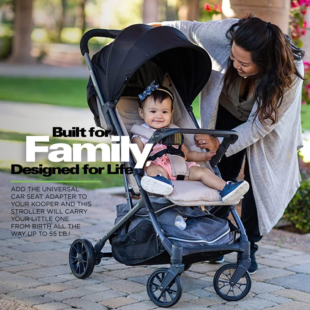 imageJoovy Kooper Lightweight Baby Stroller Featuring Removable SwingOpen Tray Big Wheels Reclining Seat with Footrest ExtraLarge Retractable Canopy and Compact Fold SandSand