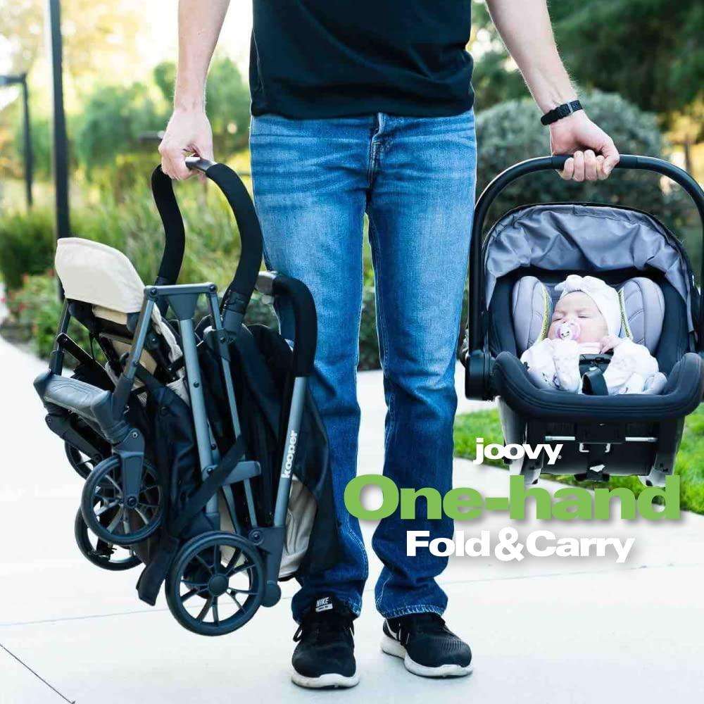 imageJoovy Kooper Lightweight Baby Stroller Featuring Removable SwingOpen Tray Big Wheels Reclining Seat with Footrest ExtraLarge Retractable Canopy and Compact Fold SandSand